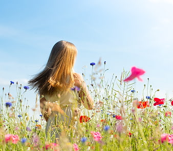 Woman in White Dress Standing in Wildflower Field