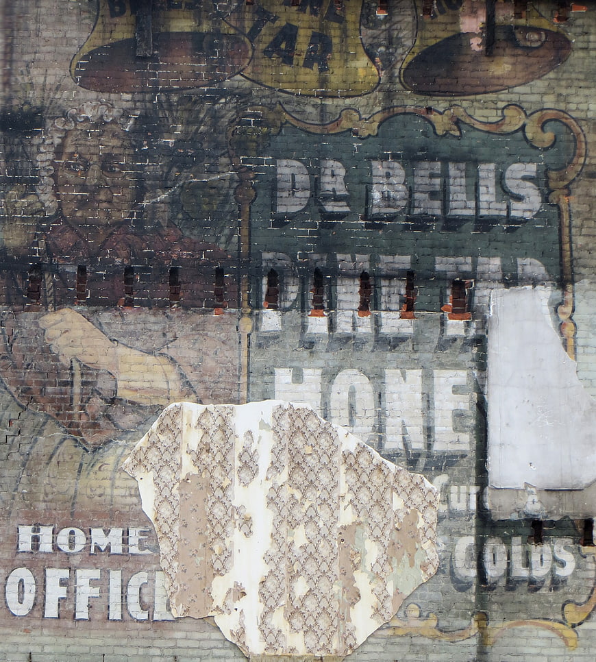 Vintage Dr Bells Medicine Advertisement on Weathered Brick Wall