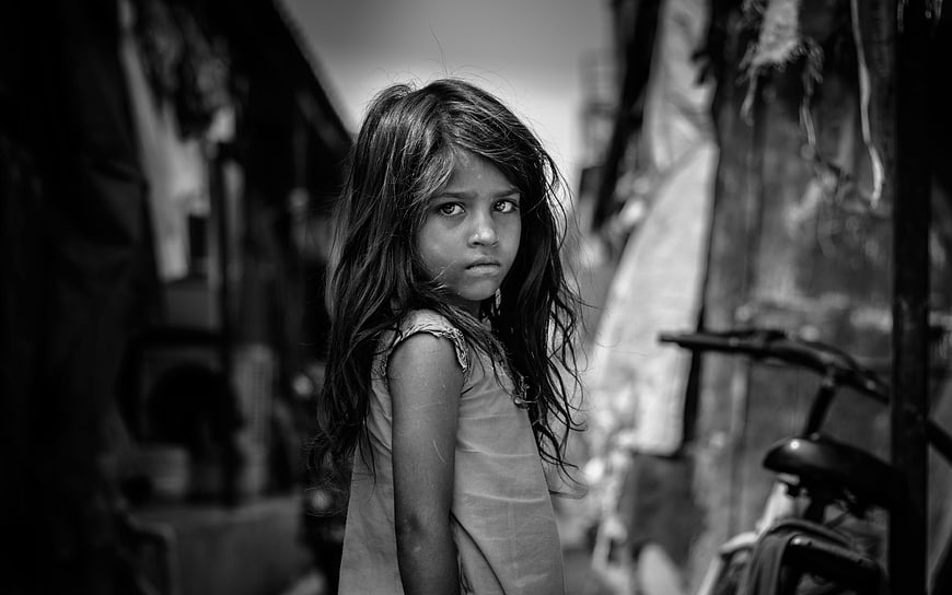 Black and white portrait of young girl in alley