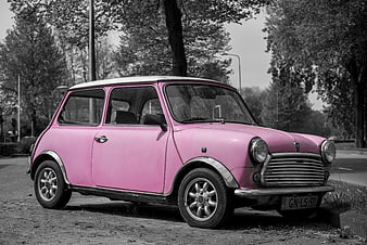 Pink Mini Cooper Classic Car on Cobblestone Street