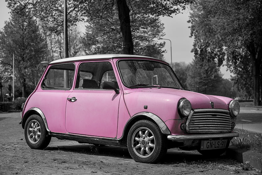 Pink Mini Cooper Classic Car on Cobblestone Street