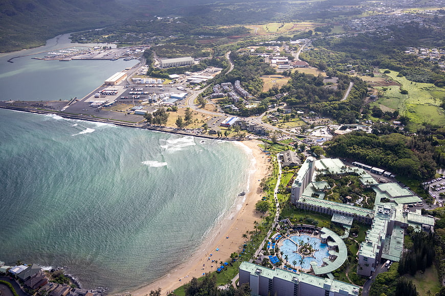 Aerial view of tropical resort, beach, and harbor coastline