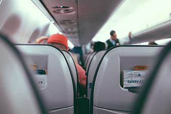 View of Airplane Cabin Interior with Passengers and Seats