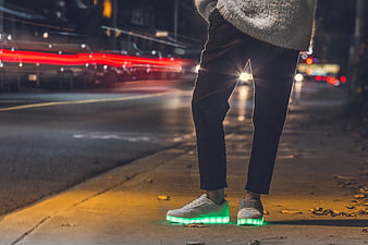 Person Wearing LED Light Up Shoes on City Street at Night