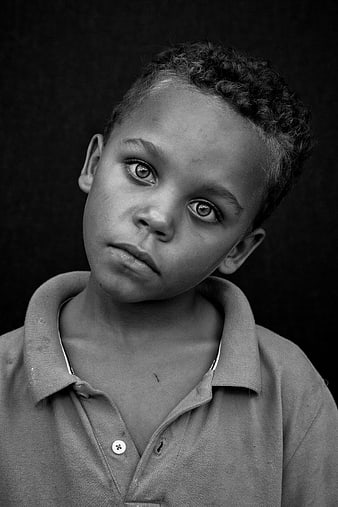 Black and white portrait of a young boy with intense gaze