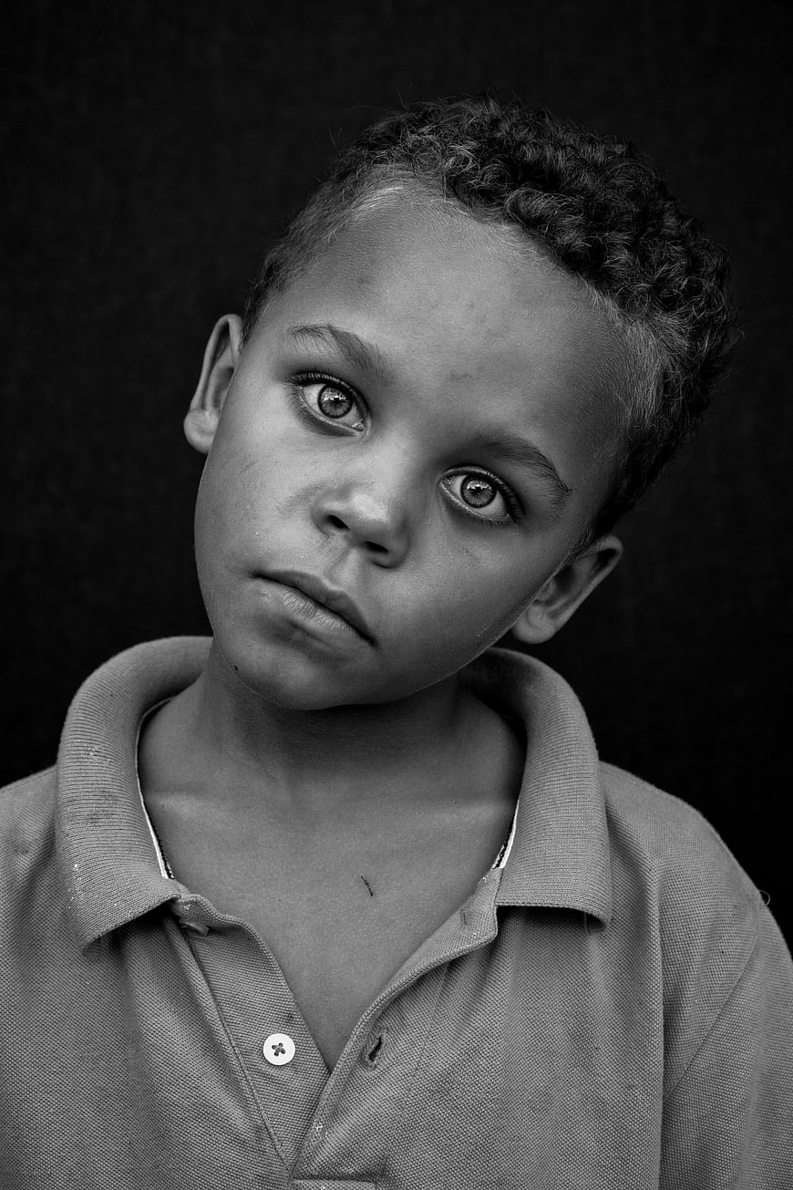 Black and white portrait of a young boy with intense gaze