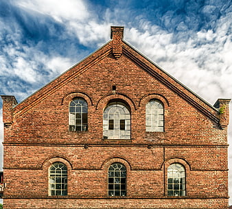 Symmetrical Red Brick Building Facade with Arched Windows