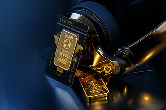 Gold bars and certificate on luxury car steering wheel