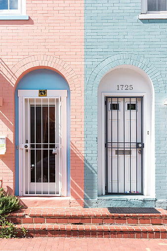 Colorful Pink and Blue Brick Townhouses with Arched Doors