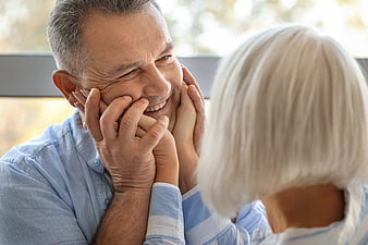 Senior couple sharing intimate affectionate moment indoors