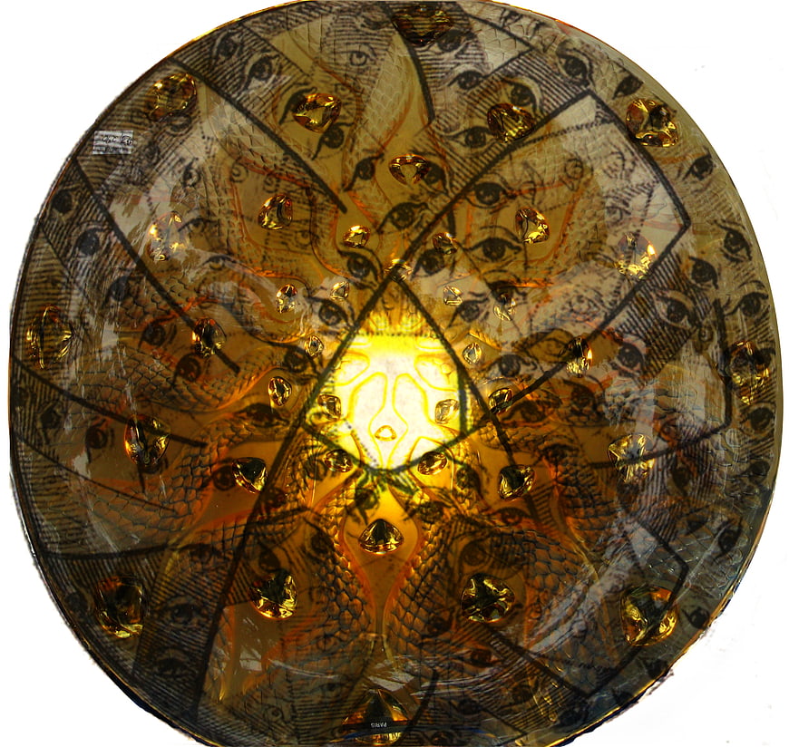Surreal golden glass plate with repeating eye pattern