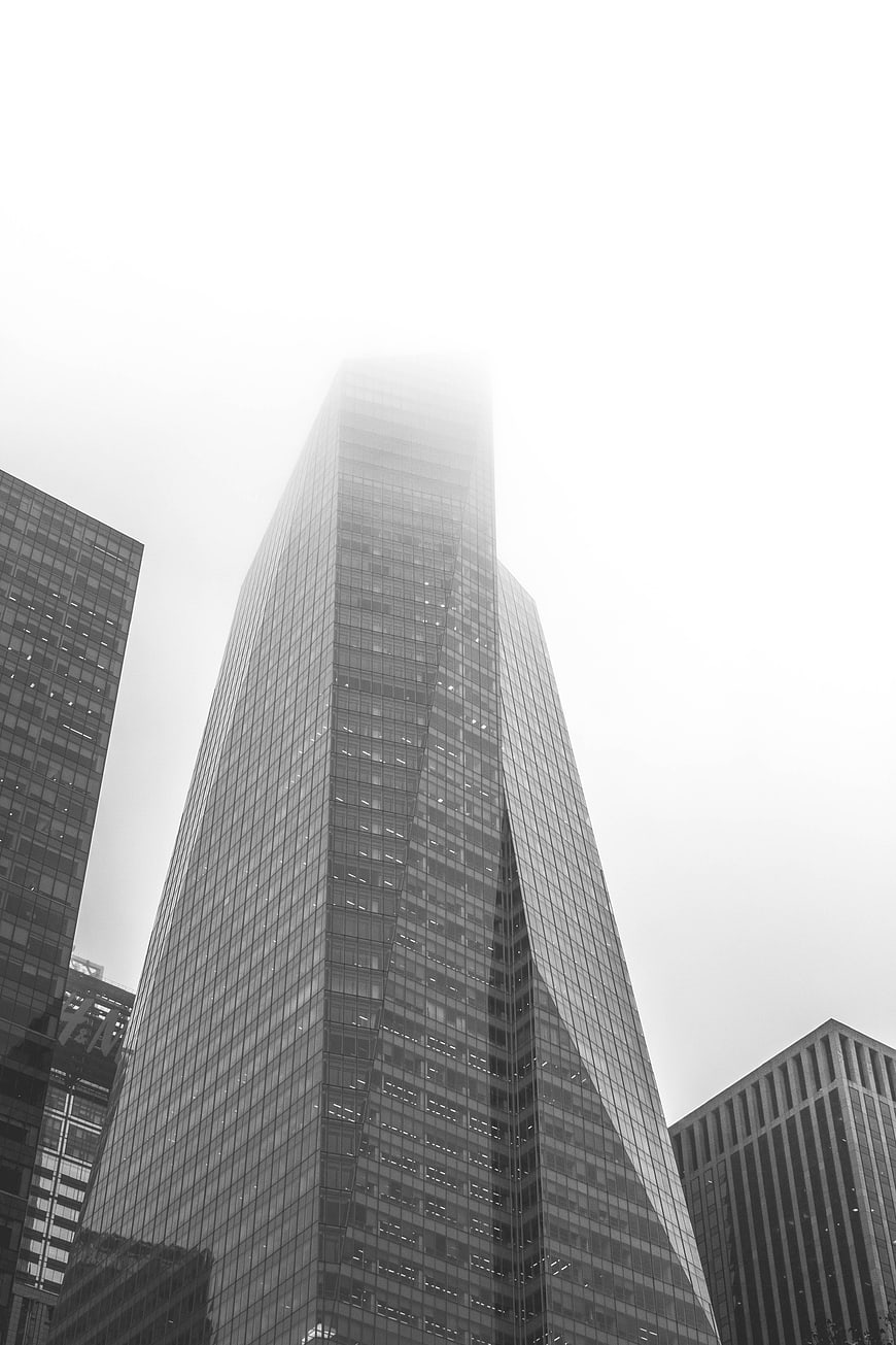 Black and white skyscraper disappearing into fog