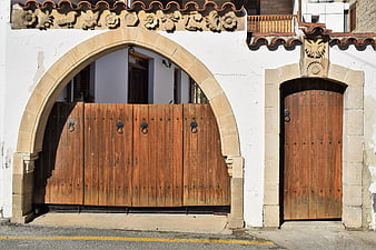 Traditional stone archway with wooden gates in Cyprus