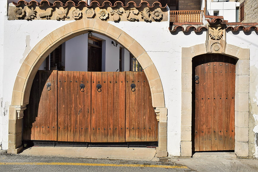 Traditional stone archway with wooden gates in Cyprus