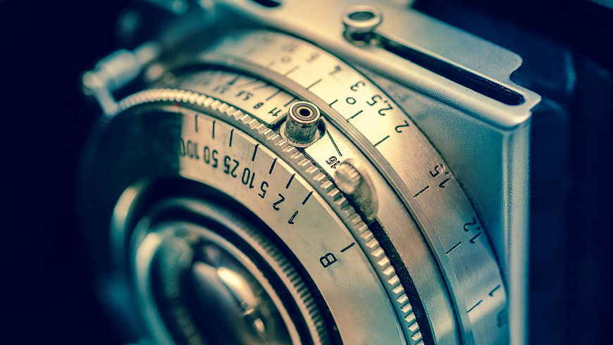 Close-up of vintage silver camera lens and aperture dials