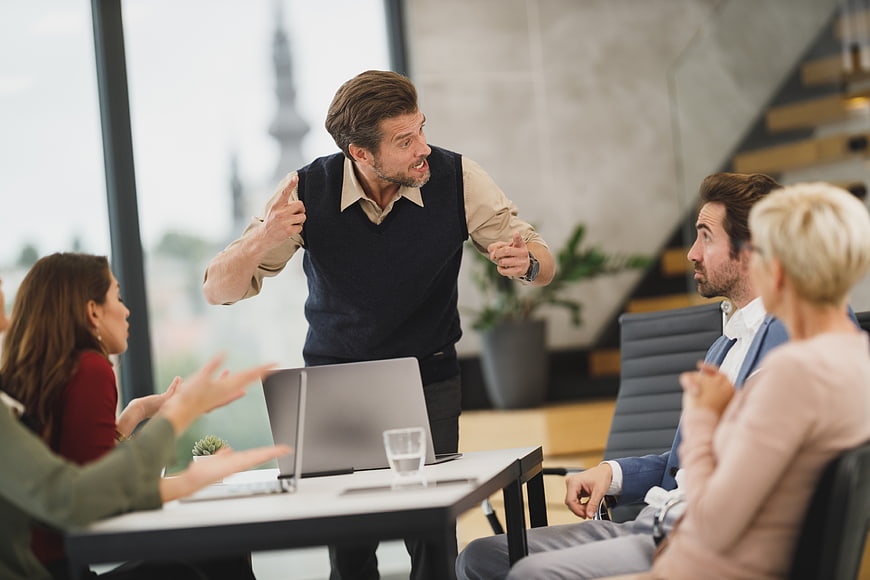 Angry Businessman Yelling at Team During Office Meeting