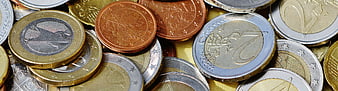 Close-up of mixed euro coins and currency