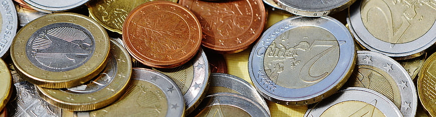 Close-up of mixed euro coins and currency