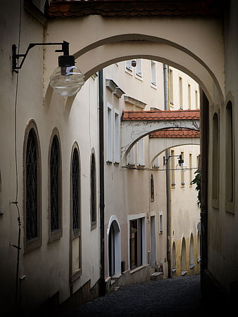 Narrow European Alley with Arched Passages and Cobblestones