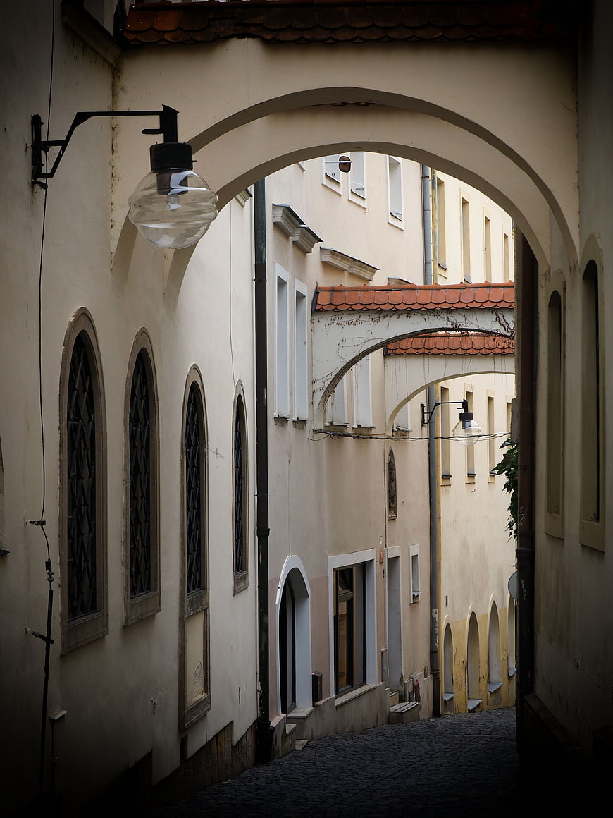 Narrow European Alley with Arched Passages and Cobblestones