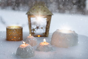 Winter Candles and Lantern in Snow with Falling Snowflakes