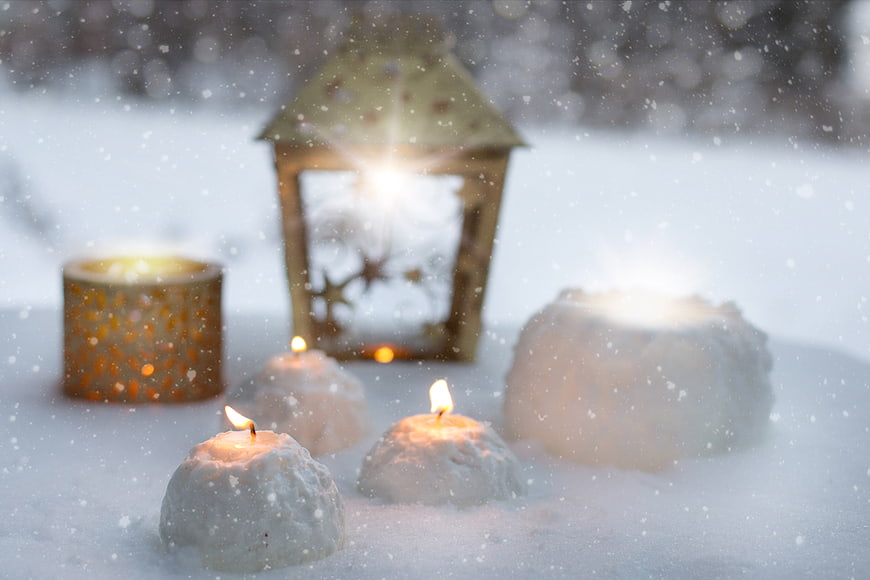 Winter Candles and Lantern in Snow with Falling Snowflakes