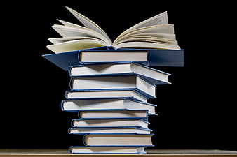 Stack of blue books with open book on top