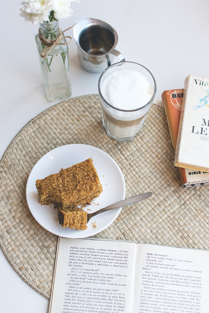 Traditional Czech honey cake with latte and books