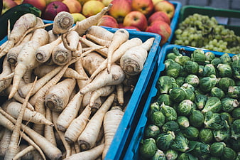 Fresh Parsnips and Brussels Sprouts in Blue Crates at Market