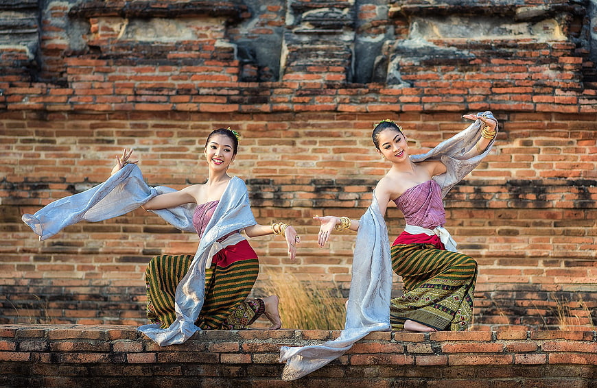 Thai dancers performing traditional dance at ancient ruins