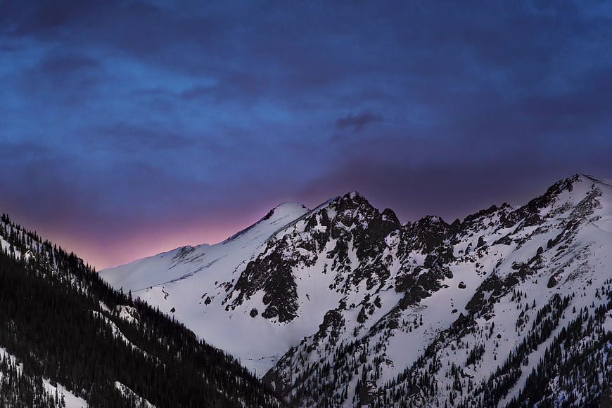 Snowy Mountain Peaks Under Purple Twilight Sky