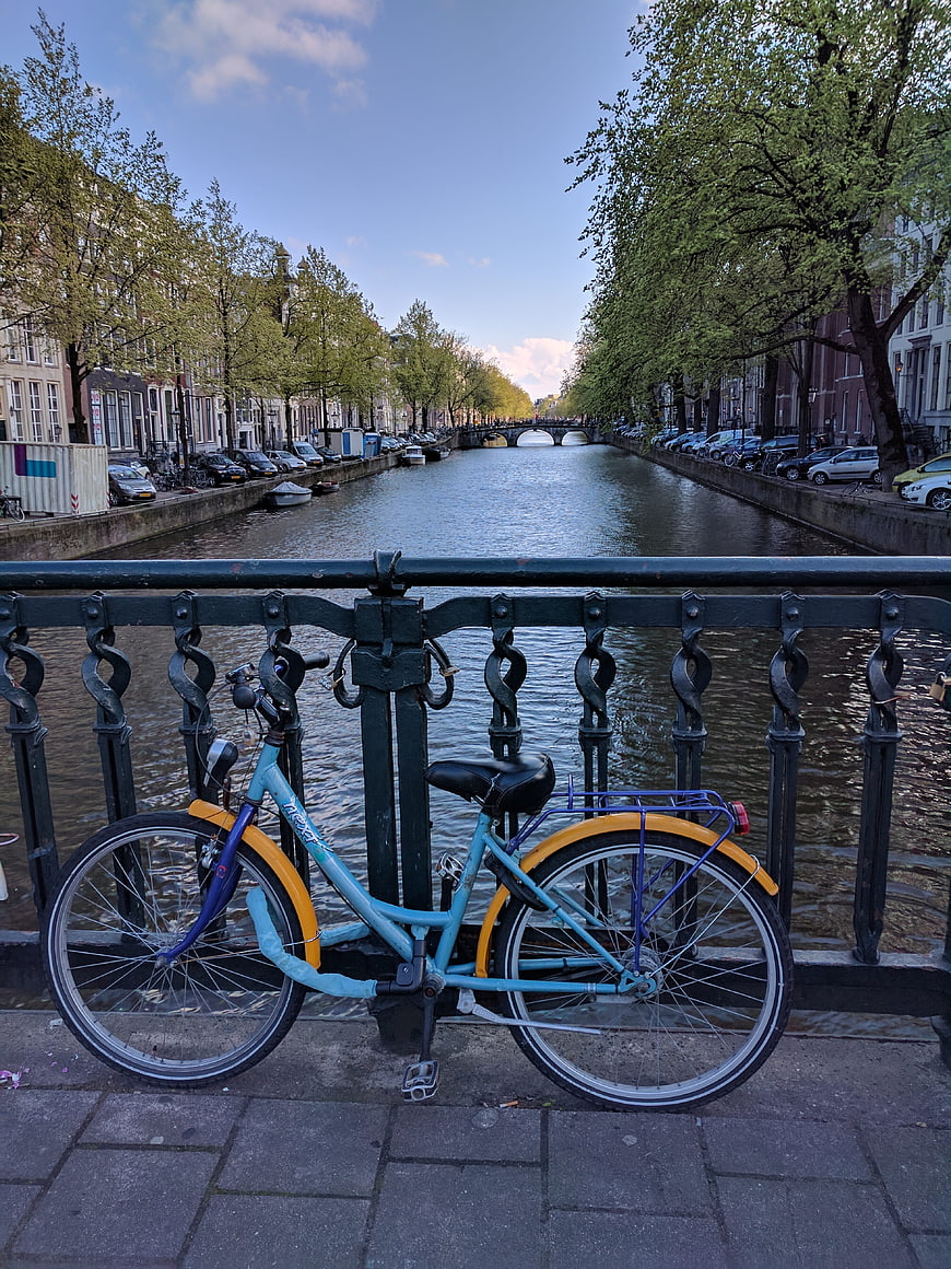 Blue Bicycle on Amsterdam Canal Bridge