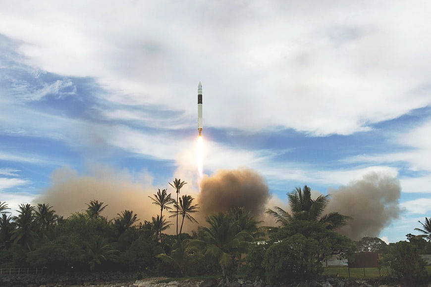 SpaceX Falcon 9 Rocket Launching Over Tropical Palm Trees
