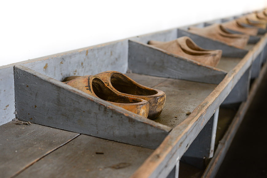 Traditional Dutch wooden clogs in a row on a shelf