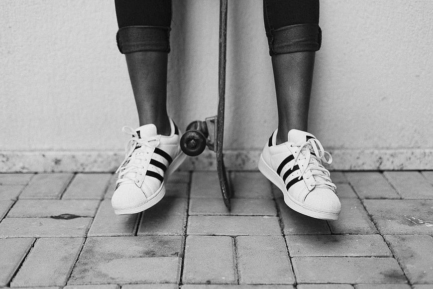 Black and White Skateboarder Legs with Sneakers