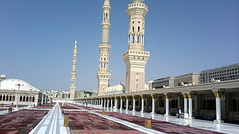Grand Mosque Courtyard with Minarets and Red Carpets