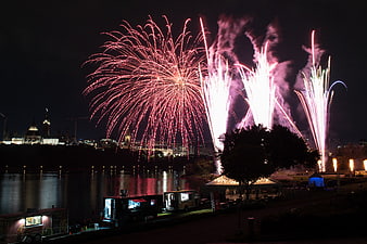 Fireworks Display Over River With Food Trucks and City Skyline