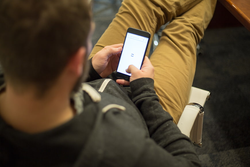 Man using smartphone while sitting in office chair