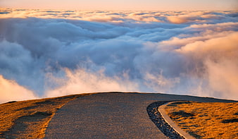 Mountain Road Leading Into Sea Of Clouds At Golden Hour