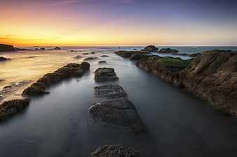 Long Exposure Sunset Over Rocky Coastal Tide Pools