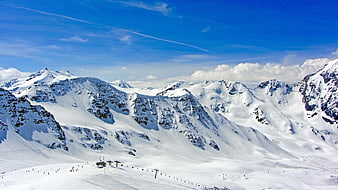 Snowy Alpine Ski Resort with Chairlifts and Blue Sky